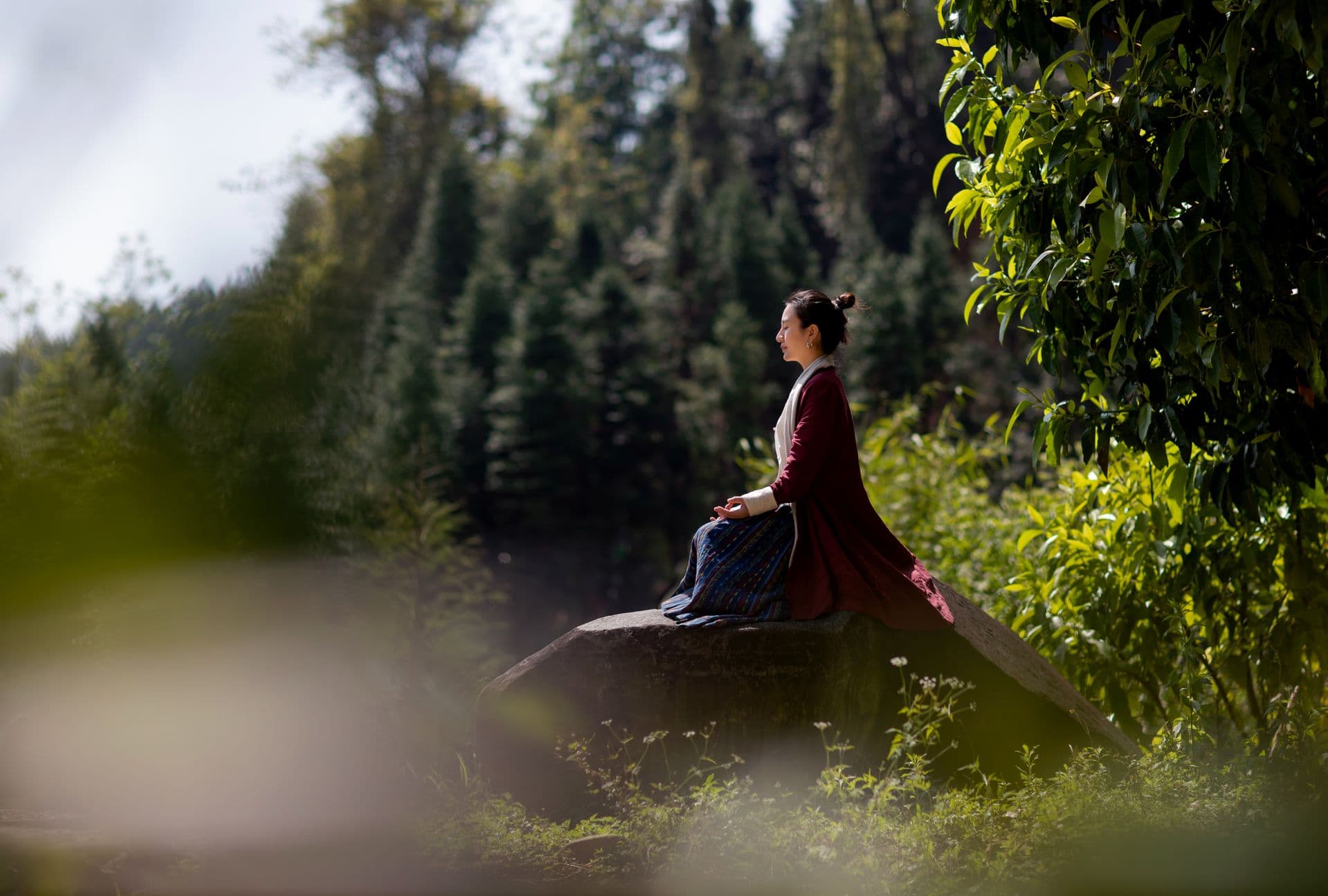 Woman meditating in nature — RelaxFrens personalised meditation app for sleep, stress, and focus